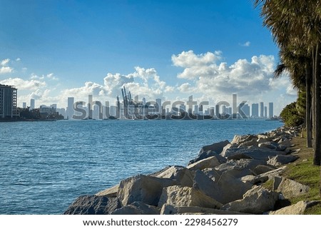 Scenic view of entrance to Port Miami seen from Miami Beach with the skyline of downtown Miami in the background against blue sky with clouds