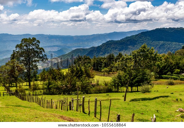 Scenic view of farm land, divided by rustic\
timber and barbed wire fence, with mountains edging the Great Rift\
Valley in the background. Kerio Valley Viewpoint, Eldoret -\
Kaptagat Road, Kenya,\
Africa.