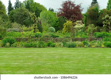 Scenic View of a Green Grass Lawn in a Beautiful Landscape Garden - Shutterstock ID 1086496226