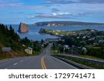 Scenic view up the hill of the village harboring the famous Rocher Percé in Gaspesie at dusk.