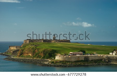 Scenic view of historic colorful Puerto Rico city in distance with fort in foreground san juan