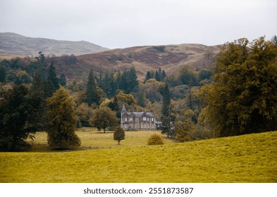 Scenic view of a historic house with a tower in the Scottish Highlands, surrounded by rugged landscapes, rolling hills, and dramatic skies. This picturesque property embodies the charm and mystery of - Powered by Shutterstock