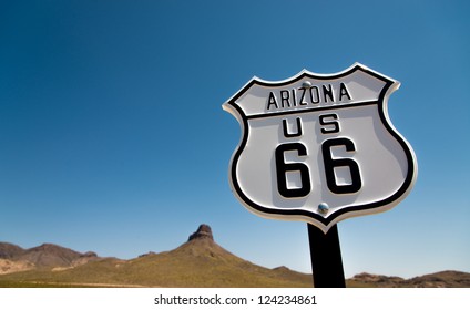 A Scenic View Of A Historic Route 66 Sign With A Sky Blue Background