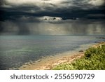 Scenic view of Hobsons Bay with dark storm clouds above in Williamstown, Melbourne, Victoria, Australia