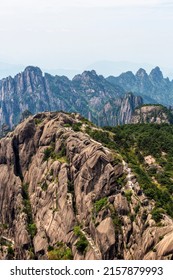 A scenic view of Huangshan mountain covered with trees against blue sky in Anhui, China