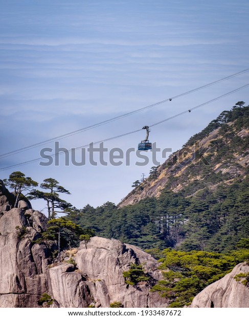 Scenic\
view of Huangshan yellow mountain cliffs in China from lift cable\
car and a lot of the mist in the winter season, Huangahan national\
park is one of  the Unesco world heritage site.\
