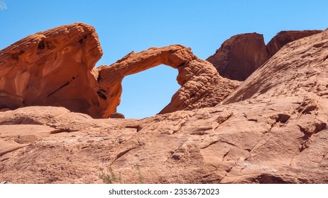 Scenic view of the iconic natural Arch Rock along Valley of Fire scenic loop,Valley of Fire State Park, Mojave desert, Nevada, USA. Landscape of Aztek red sandstone rock formations in barren terrain - Powered by Shutterstock