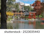 Scenic view of the Japanese Garden in Buenos Aires, featuring traditional structures and lush greenery around a pond.