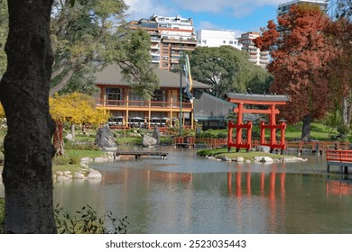 Scenic view of the Japanese Garden in Buenos Aires, featuring traditional structures and lush greenery around a pond. - Powered by Shutterstock