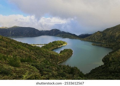 A scenic view of Lagoa do Fogo, a crater lake on Sao Miguel Island in the Azores, Portugal, surrounded by lush green hills under a cloudy sky. - Powered by Shutterstock