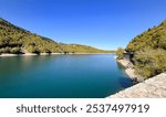 A scenic view of Lake Plastiras, an artificial lake fed by the Tavropos (Megdovas) River, located near the city of Karditsa, Greece. This popular resort offers serene natural beauty.