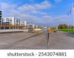 Scenic view of lake with reed and modern apartment buildings with blue cloudy sky on an autumn day at Swiss town of Opfikon Glattbrugg. Photo taken November 8th, 2024, Zurich Opfikon, Switzerland.