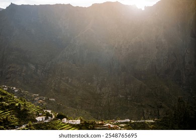 Scenic view of the landmark Masca Canyon, a green valley with a small town among the rocky mountains Masca Gorge in the rays of a sun, Tenerife, Canary Islands. - Powered by Shutterstock