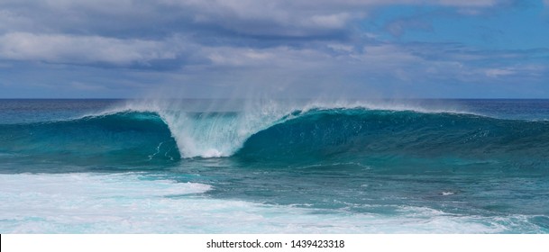 Scenic View Of A Large Turquoise Breaking Wave Approaching The Shoreline Of Beautiful Easter Island. Beautiful Tube Wave Rolls Towards The Coast Of An Exotic Island In The Endless Pacific Ocean.