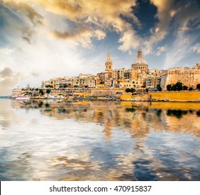 scenic View of Marsamxett Harbour and Valletta in Malta at sunset with reflection