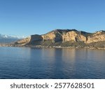 Scenic view of Monte Pellegrino in Palermo, Sicily, with clear blue skies and calm sea waters.