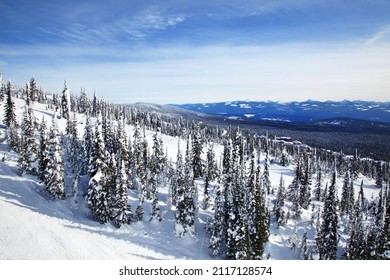 A Scenic View Of A Mountain Covered With Snow And Pine Trees In British Colombia, Canada