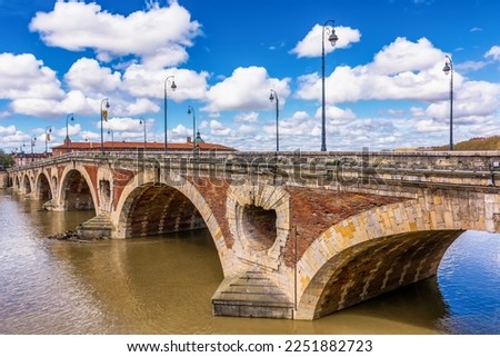 Scenic view of old bridge in Toulouse against spring dramatic sky