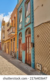 Scenic view of old historic houses, residential buildings, and traditional infrastructure in cobblestone city alleyways, streets, and roads. Tourism abroad and travel to Santa Cruz, La Palma, Spain