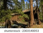 Scenic view of the old wooden Wawona Covered Bridge over Merced River, Yosemite National Park, Sierra Nevada mountain range in California, USA