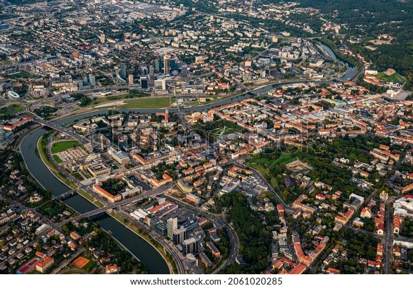 Scenic view on\
central part of Vilnius capital of Lithuania from hot air balloon.\
Neris river flowing curve through the city. Downtown district\
cityscape view from the\
sky