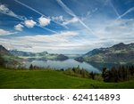 Scenic view on Vierwaldstättersee (Lago dei Quattro Cantoni, Lago di Lucerna, Lai dals Quatter Chantuns) with lake, snowy mountians, blue sky, clouds, meadows and forests from Emmetten, Switzerland