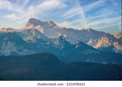 Scenic view on Triglav summit and biggest mountain range of Julian Alps from Vogel. Mountain peaks illuminated by sunset. Triglav is a highest mount and symbol of Slovenia