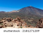 Scenic view on volcano Pico del Teide seen from Riscos de la Fortaleza, Mount El Teide National Park, Tenerife, Canary Islands, Spain, Europe. Hike via La Canada de los Guancheros dry desert plain