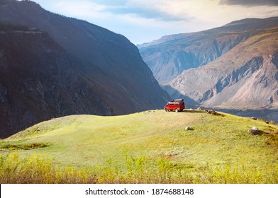 Scenic View Over Tourist Off Road Red Car, Standing At The Edge Of The Mountain. Altai Autumn Landscape, Russia