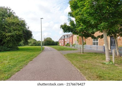 Scenic View Of A Path Through A Suburban Park