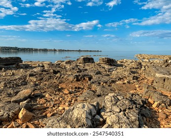 Scenic view of picturesque coastal town Dajla seen from rocky shoreline of Karigador, Istria peninsula, Croatia. Village is nestled along the waterfront of Adriatic Mediterranean sea. Summer vacation - Powered by Shutterstock