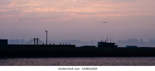 A scenic view of the port of Dalian on bright sunset sky background