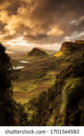Scenic view of Quiraing mountains in Isle of Skye, Scottish highlands, United Kingdom. Sunrise time with colourful an rayini clouds in background