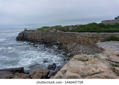 Scenic View Of Rock Wall Along Oceanshore