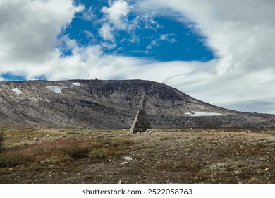 Scenic View of a Rocky Mound Beneath a Dramatic Sky in Norway's Mountain Range During Winter - Powered by Shutterstock