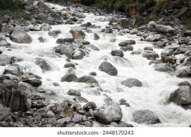 Scenic view of rocky mountain river flowing through rocks on sunny day in national park. Clean mountain stream flowing in nature. Rocky stream. Water flowing downwards over cliffs and rocks, close up.