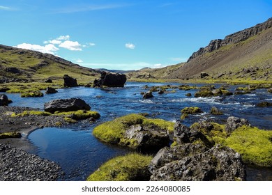Scenic View of Rocky Mountains and River, Iceland: This stock image showcases the breathtaking beauty of rocky mountains and a river in Iceland.
