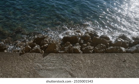 A scenic view of the rocky shoreline and clear blue sea in gallipoli, puglia, salento, italy, showcasing the beautiful seaside landscape during a sunny day. - Powered by Shutterstock