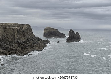 Scenic view of the rugged cliffs and the Atlantic Ocean at Cabo San Vicente, Portugal. The unique rock formations and misty atmosphere create a dramatic coastal landscape. - Powered by Shutterstock