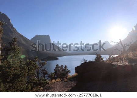 Similar – Image, Stock Photo Sunlit peak of a massive rock formation with the Caminito del Rey path along the side in Malaga