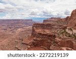 Scenic view from Shafer Trail Viewpoint in Canyonlands National Park near Moab, Utah, USA. Shafer Basin and La Sal Mountains in  Colorado Plateau in distance. Off road trails leading down the canyon