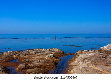 Scenic View Of Sicily Sea Where An Elderly Man Fishing With Sticks