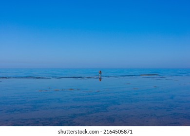 Scenic View Of Sicily Sea Where An Elderly Man Fishing With Sticks