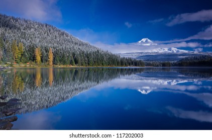 Scenic view of snow capped mountain and its reflection in lake in foreground. Mount Hood and Trillium Lake after fresh snowfall.