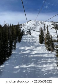 Scenic View Of Snow Covered Slopes At Big Sky Ski Resort As Seen From The Chairlift On A Sunny Winter Day