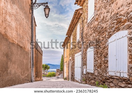 Scenic view of street in the old village of Gassin in Saint Tropez bay area in south of France against dramatic sunset sky