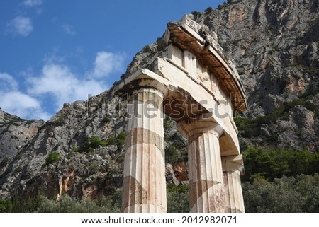 Scenic view of the Tholos Doric order columns with the pediment, triglyph and metope at the sanctuary of Athena Pronaia the sacred archaeological site in Delphi, Phocis Greece. 