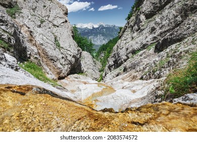 Scenic view of Totes Gebirge mountainrange with cascade at Dolomitensteig path in Upper Austria in summer.