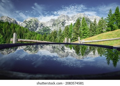 Scenic view of Totes Gebirge mountainrange with reflections on water in a barrel. Shot taken in Stodertal Vallery in the Upper Austrian Limestone Alps in summer.