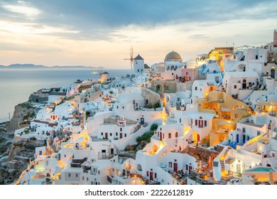 Scenic view of traditional cycladic white houses and blue domes in Oia village, Santorini island, Greece - Shutterstock ID 2222612819